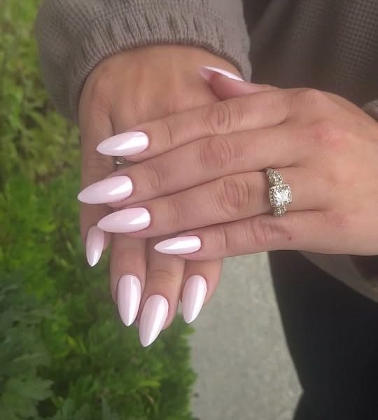 Long milky pink almond nails with a pearly finish